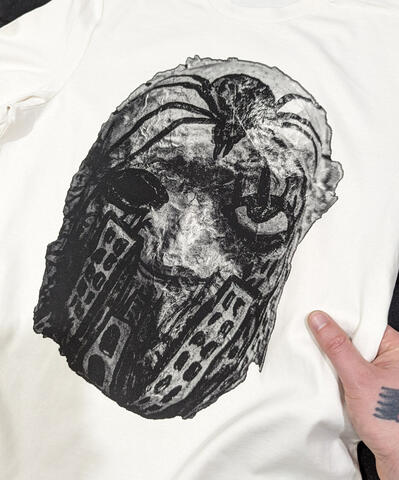 Screen printed organic cotton t-shirt featuring a photograph of a hand-painted papier-mâché mask
